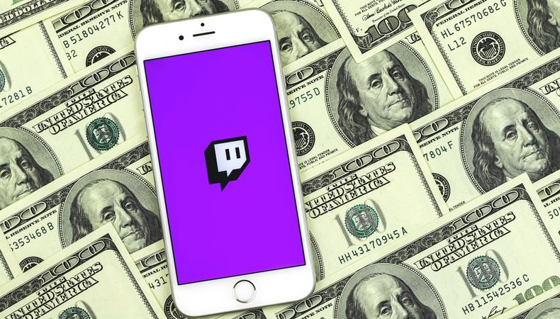 Image shows money and twitch logo in a phone for how can streaming twitch become a job 